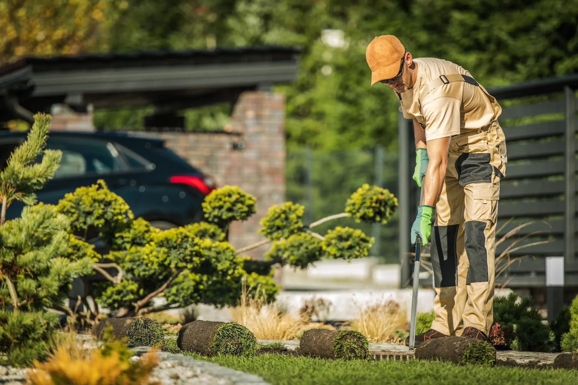 Landscaper trimming a garden shrub