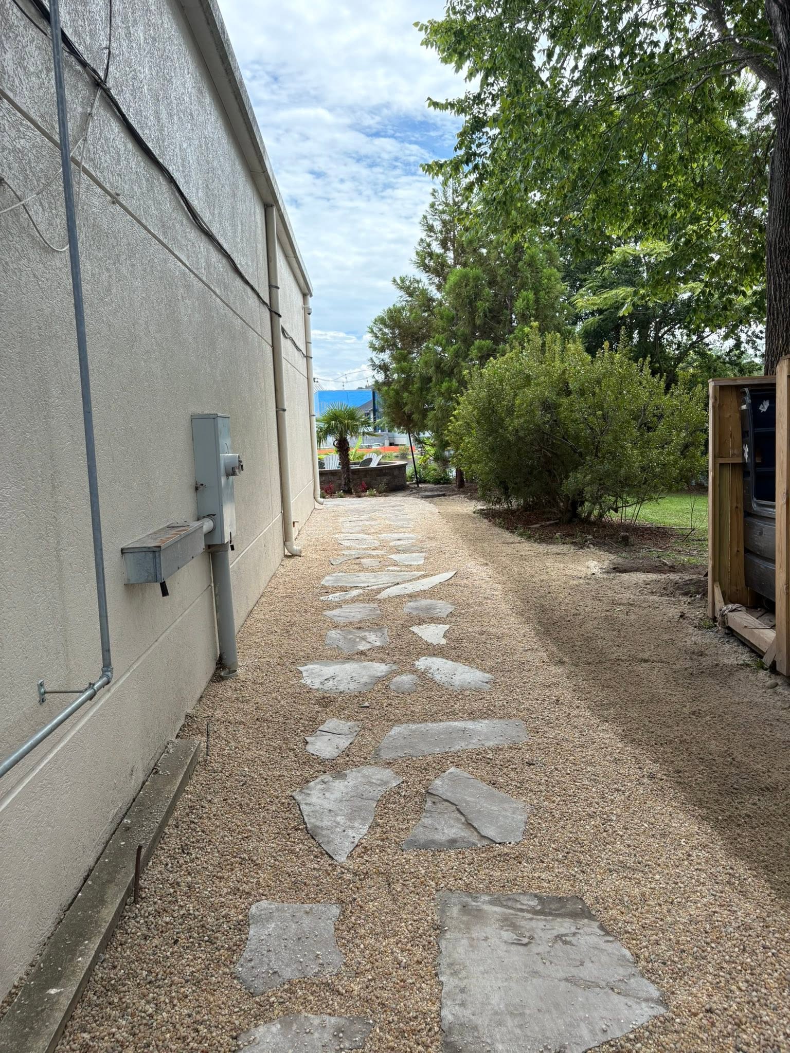 Stepping stone path along the side of a house