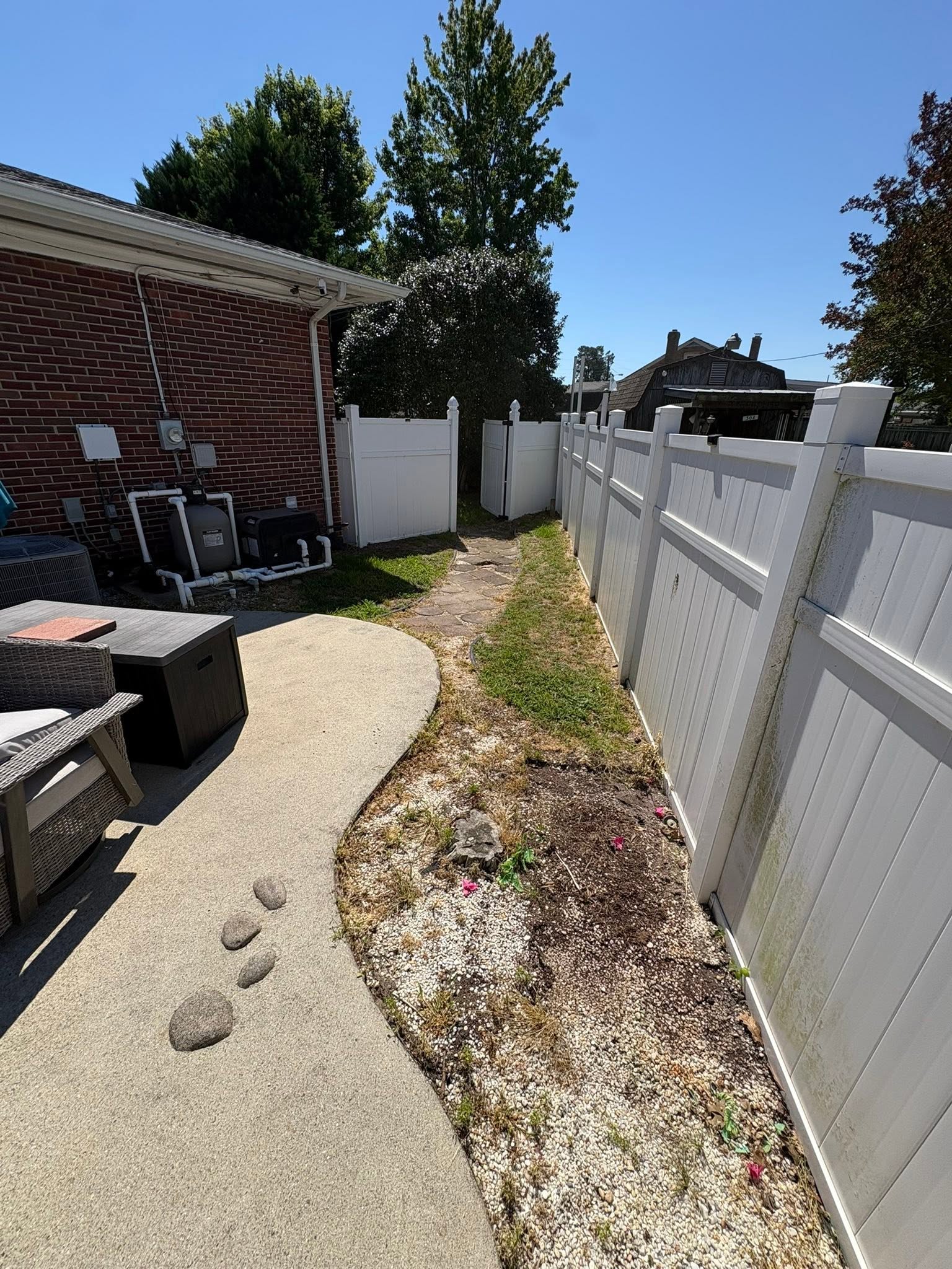 Side yard walkway along a vinyl fence