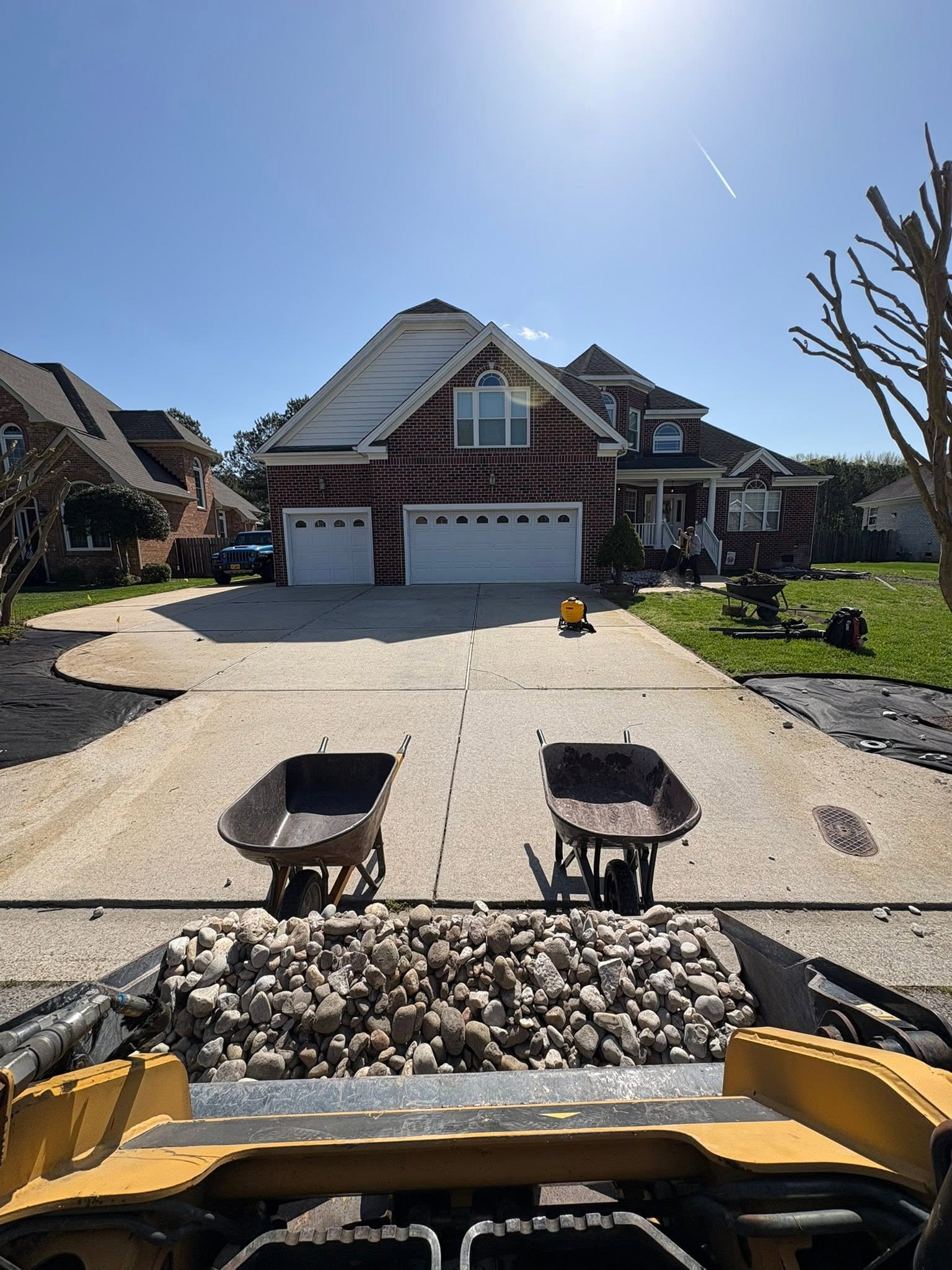 Driveway site preparation with wheelbarrows