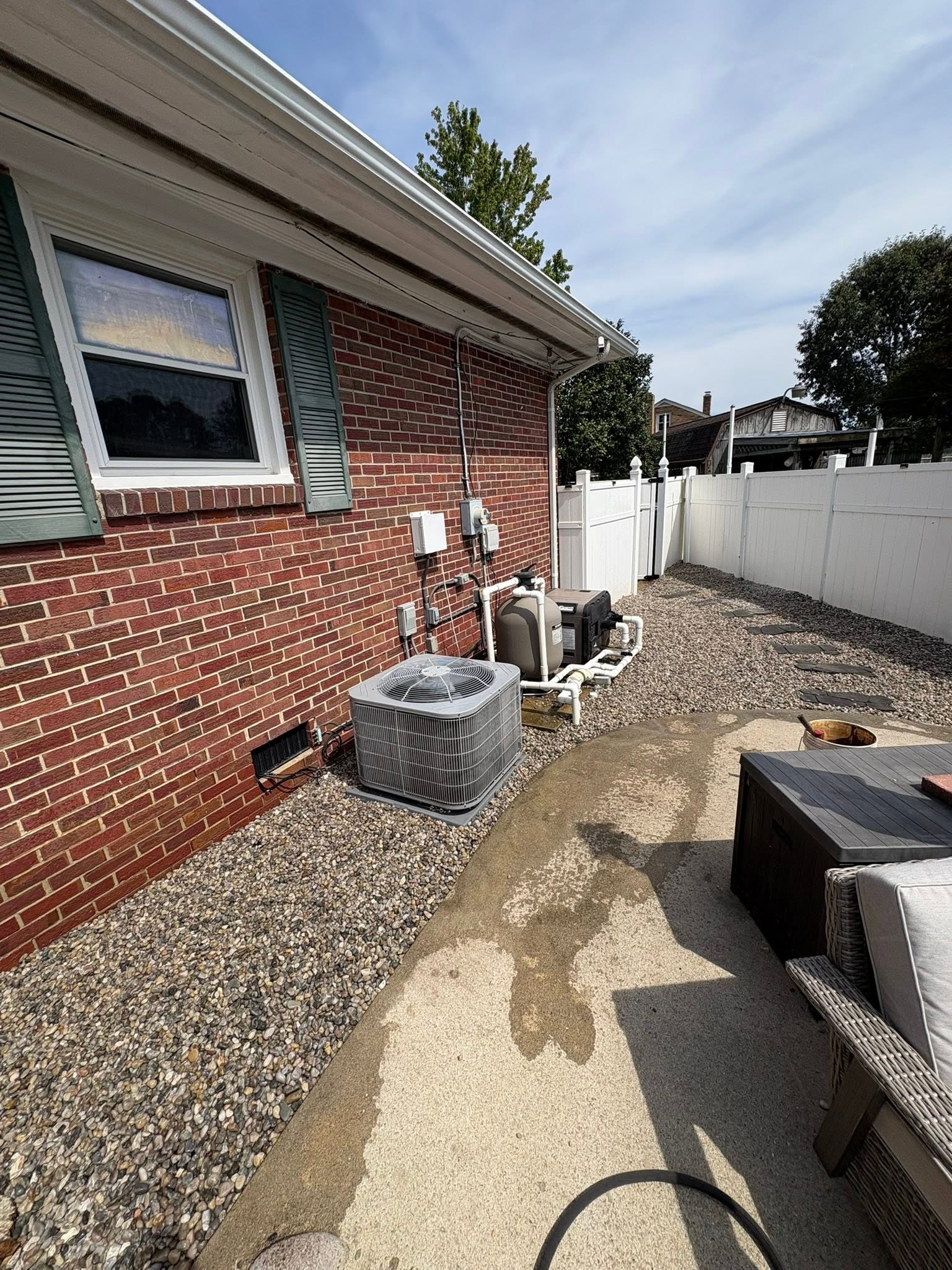 Graded side yard beside a brick home