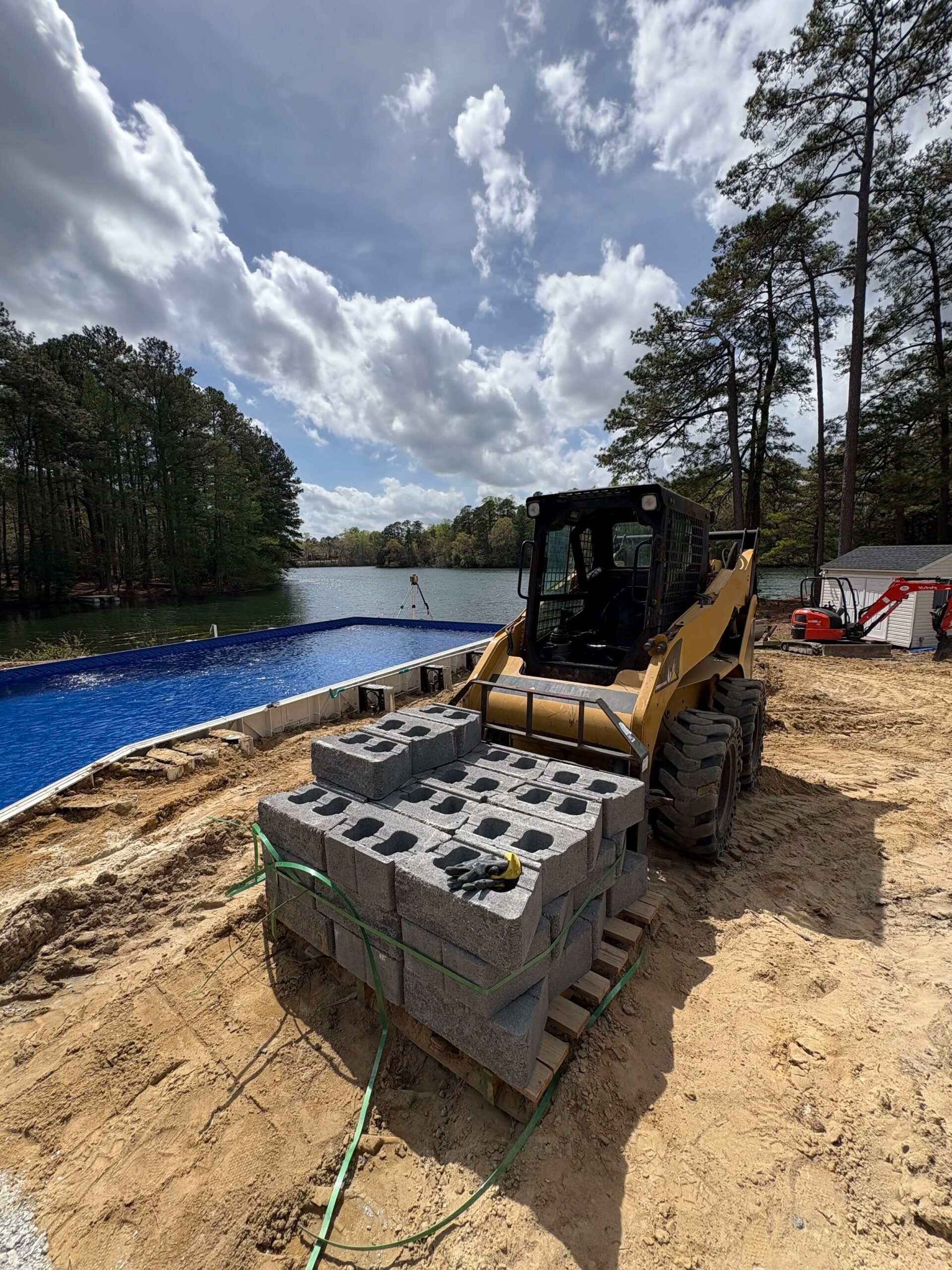 Skid steer moving retaining wall blocks