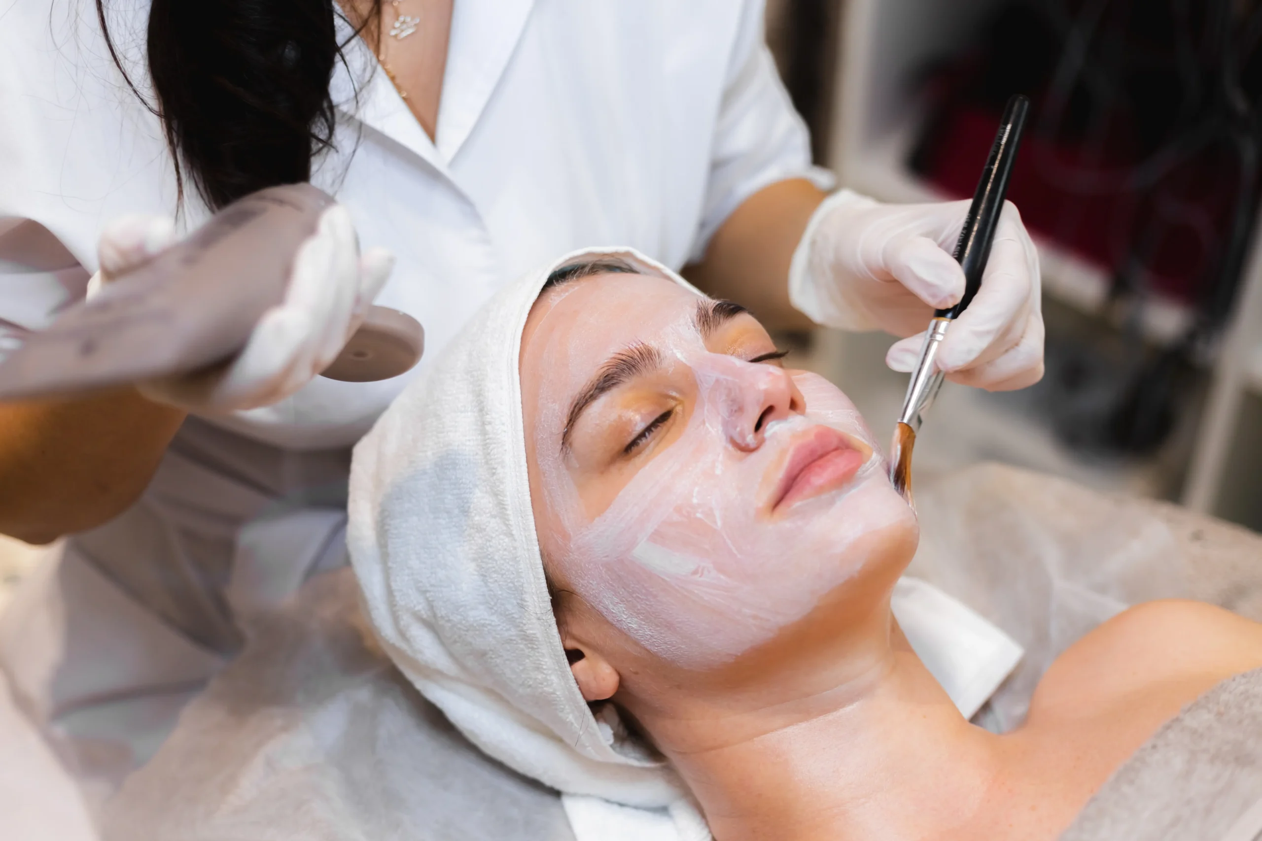 beautician-with-brush-applies-white-moisturizing-mask-face-young-girl-client-spa-beauty-salon-scaled.webp beautician-with-brush-applies-white-moisturizing-mask-face-young-girl-client-spa-beauty-salon-scaled.webp